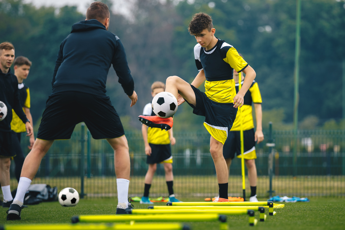 Teenage Football Players Training on Field 